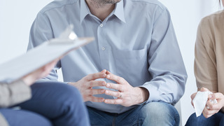 Conflicted husband and wife during divorce mediation with psychologist