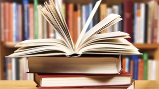 A pile of books with library on the back