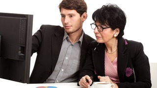 Coworkers during analysing computer data in office
